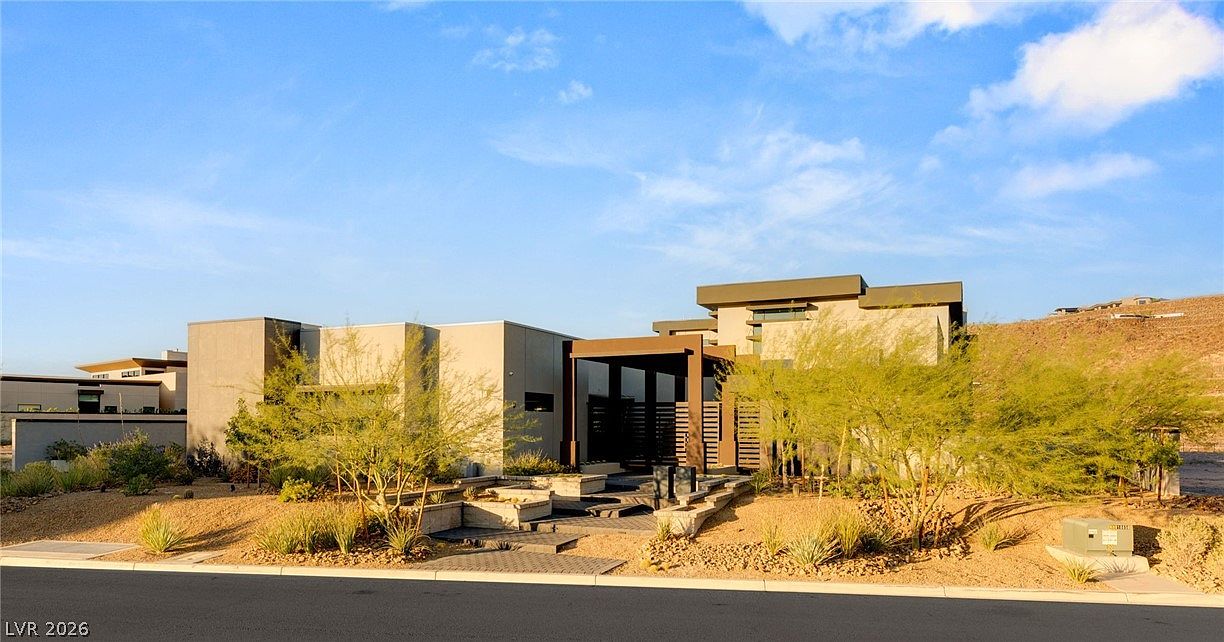 Daylight elevation of the desert contemporary residence showing horizontal massing and bronze entry pavilion